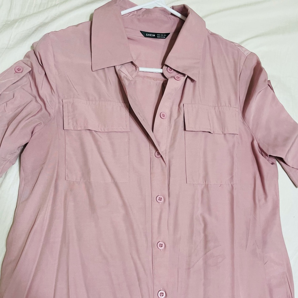 Pink button up blouse.